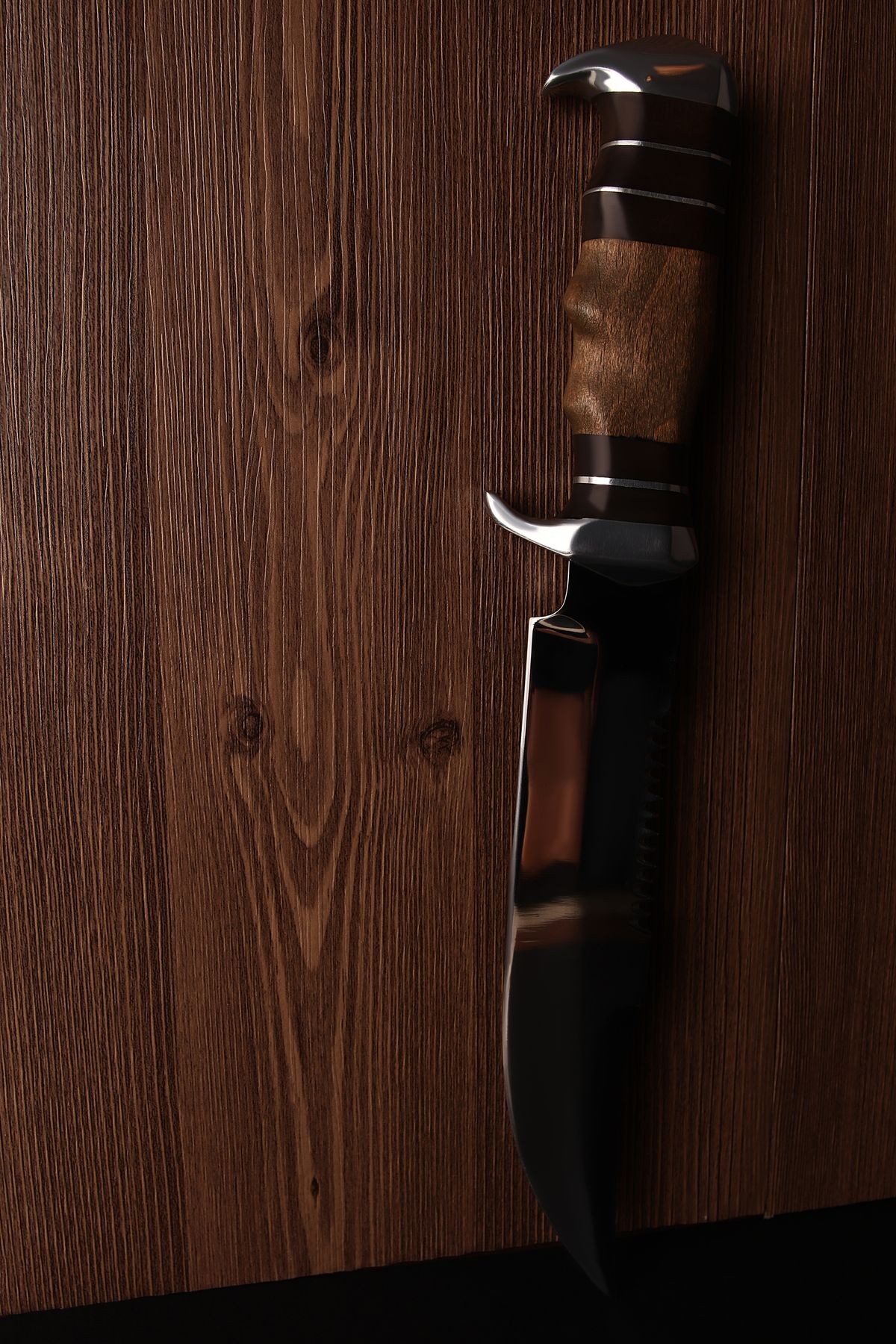 one knife with wooden handle on wooden background