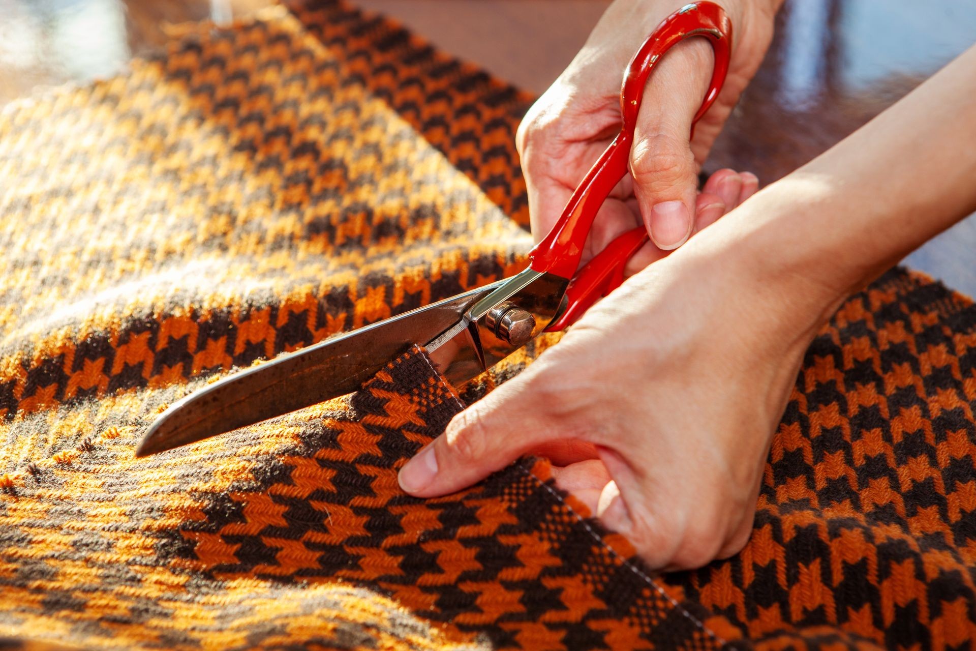 scissor sharpening, shear sharpening, industrial scissors, woman working in a sewing studio: cutting fabric with industrial scissors. Fashion designer upholstery